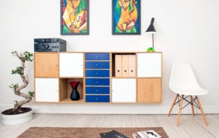 an image of two paintings hanging over a shelving unit for the Aardvark Art Services blog