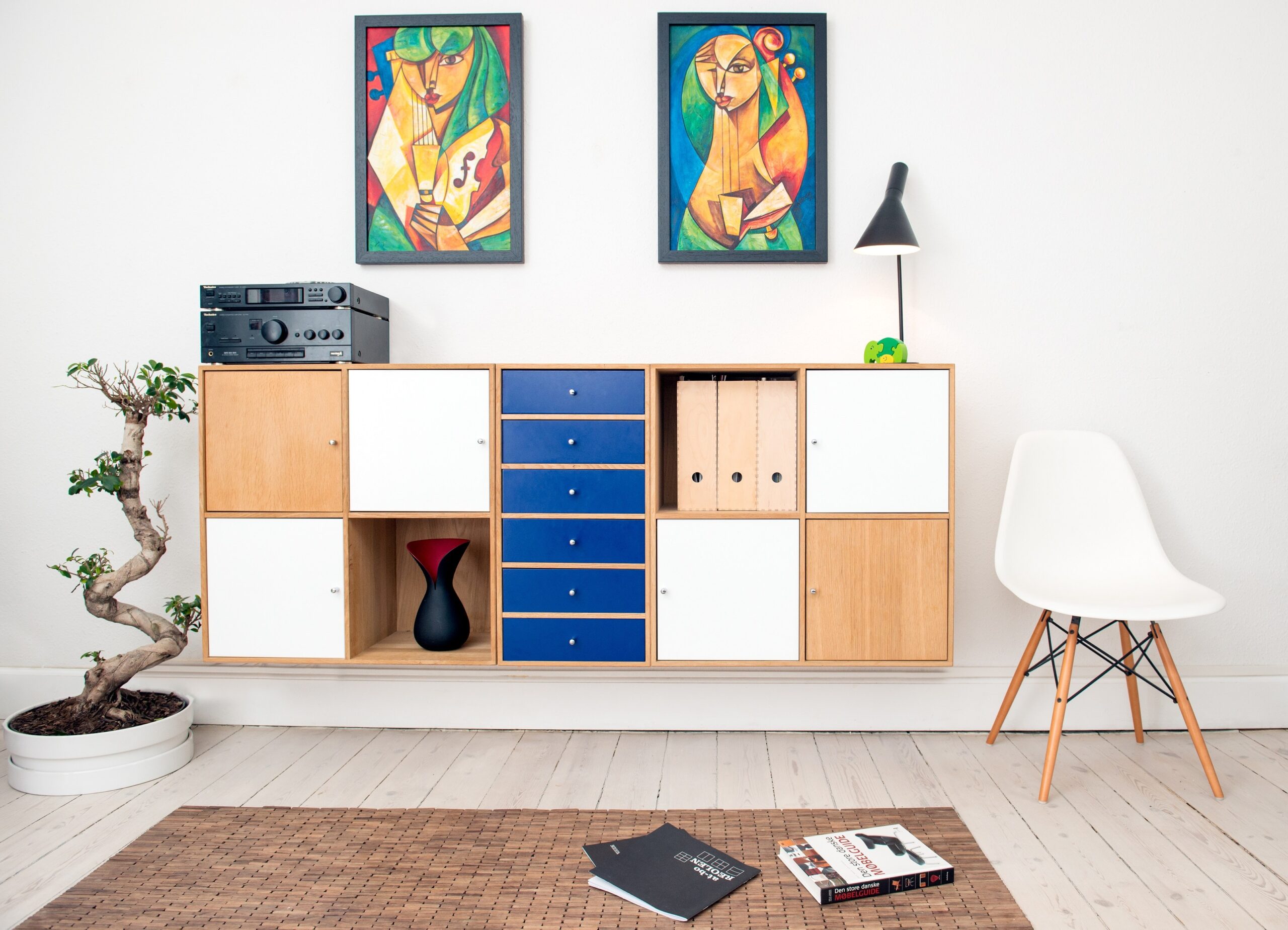 an image of two paintings hanging over a shelving unit for the Aardvark Art Services blog