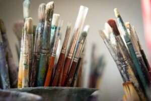 an image of dirty paint brushes for the blog Top 6 Essentials When Buying Art