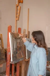 Image of woman painting for blog How to Protect Your Collection During Transportation