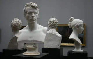 Image of 4 sculptures in the shape of a head for the Why Fine Art Shippers Are Essential For Art Collectors Aardvark Art Services blog