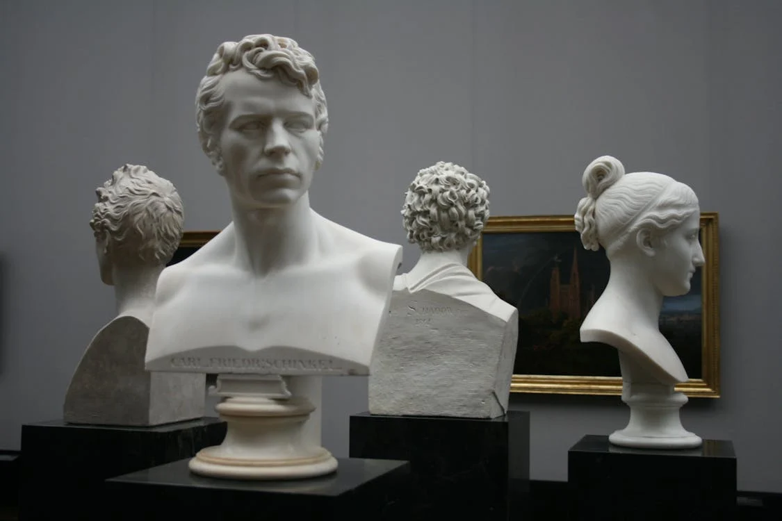 Image of 4 sculptures in the shape of a head for the Why Fine Art Shippers Are Essential For Art Collectors Aardvark Art Services blog