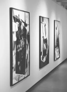Image of art collection hung up in a gallery for the blog Shipping Paintings With Confidence